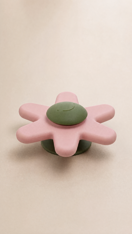 Pink and green flower-shaped object on a beige background